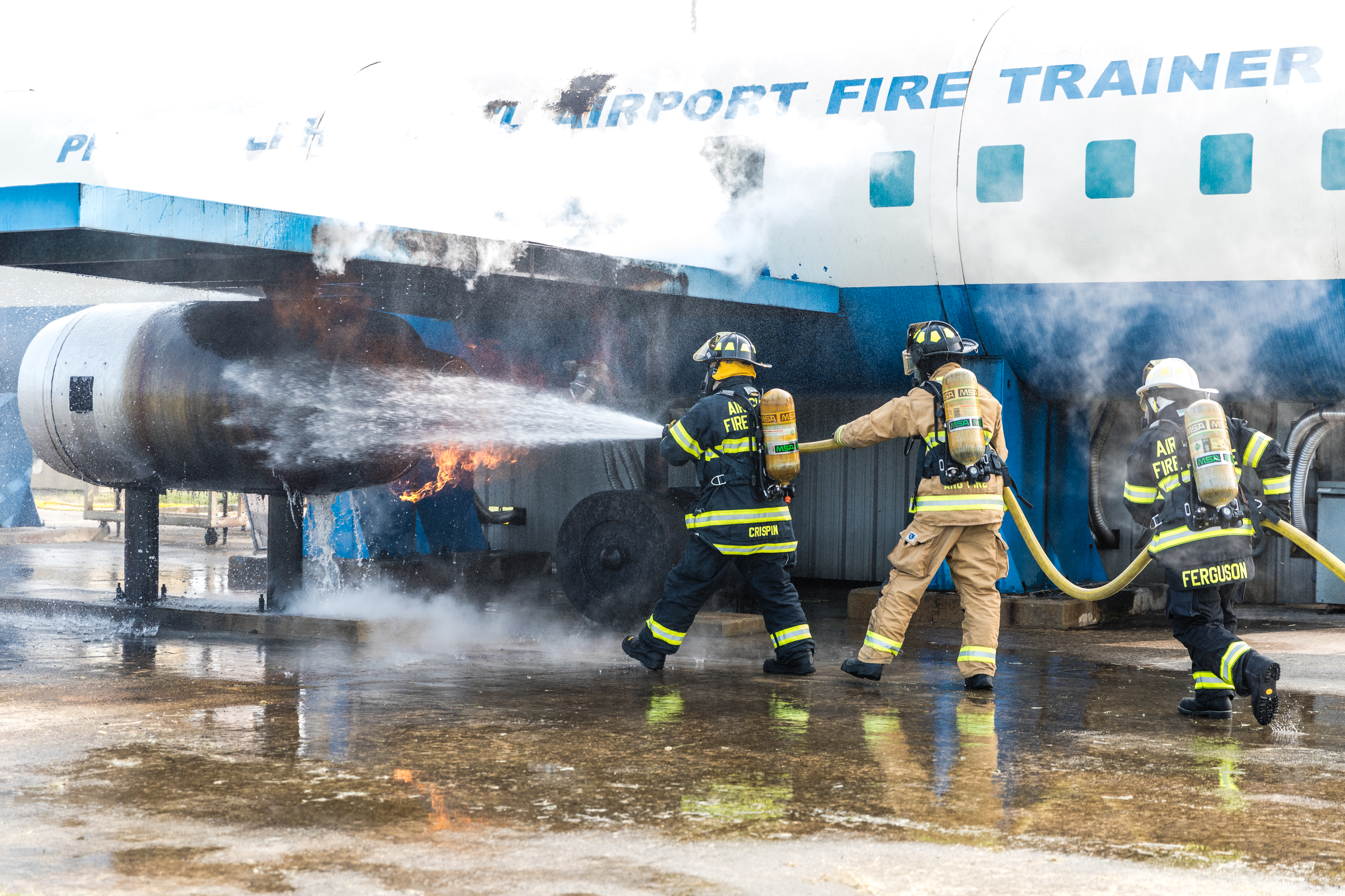 ARFF Firefighters put out a simulated blaze on the Special Aircraft Fire Trainer at PHL.
