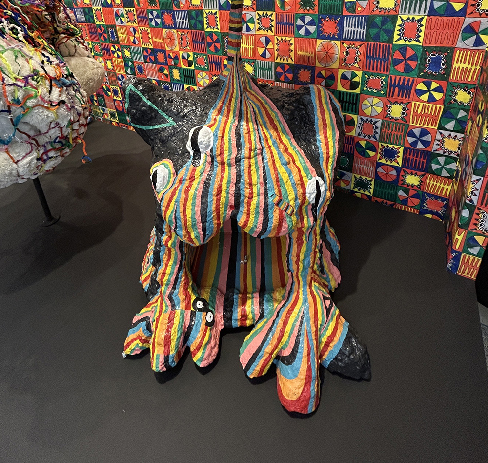 brightly painted and patterned sculpture of an imaginary creature