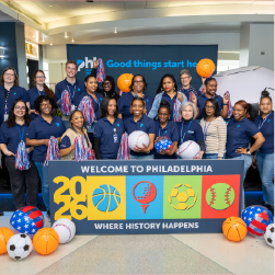 group of PHL employees in front of welcome Philadelphia sign