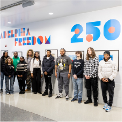group of students standing in front of wall that says Philadelphia freedom 250