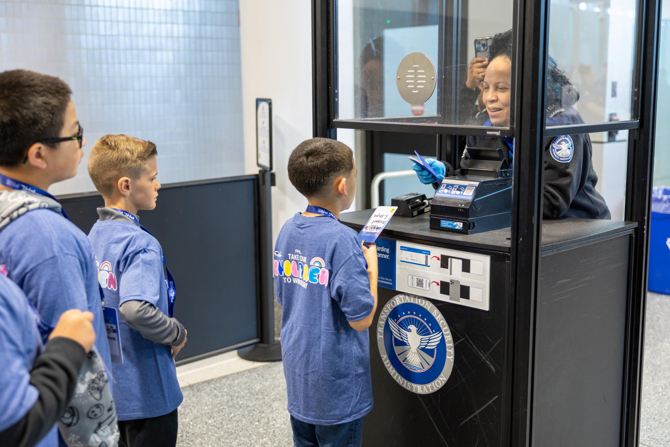 A TSA officer check the "identification" of children visiting PHL. 