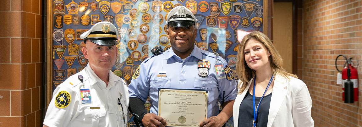Officer Davis holding award