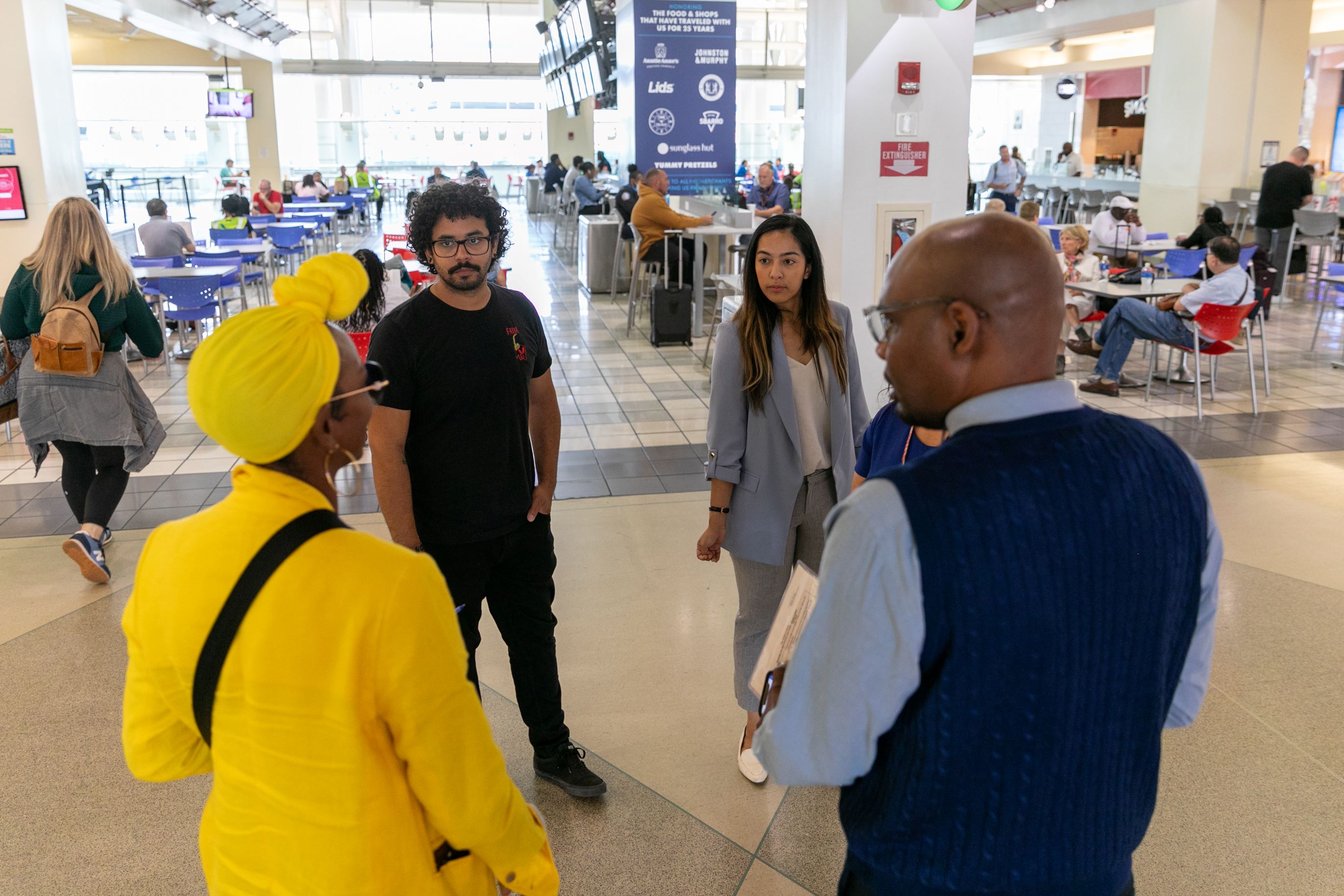 Four people in airport food court
