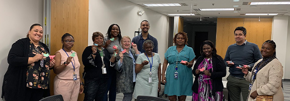 staff holding up their origami