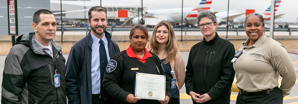 Anna Anil with guest experience team and coworkers holding certificate