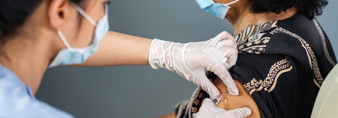 doctor administering vaccine 