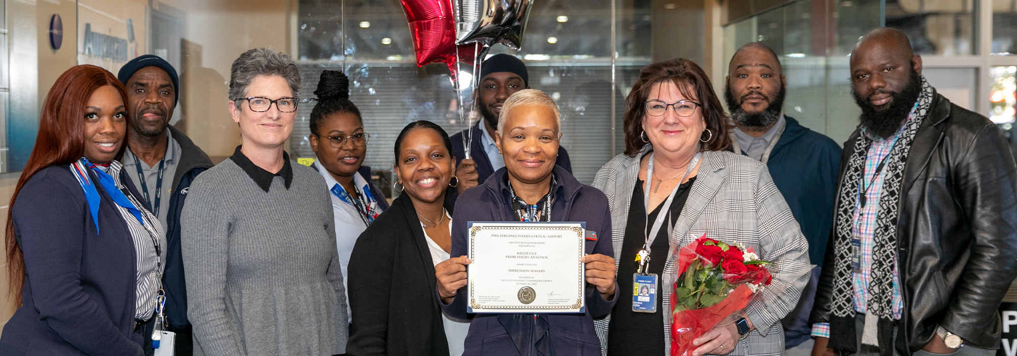 Kellie with colleagues holding award 
