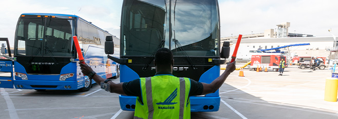 2 blue landline buses on airfield 