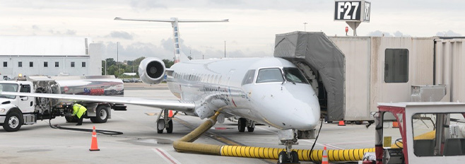 plane at gate connected to yellow tube