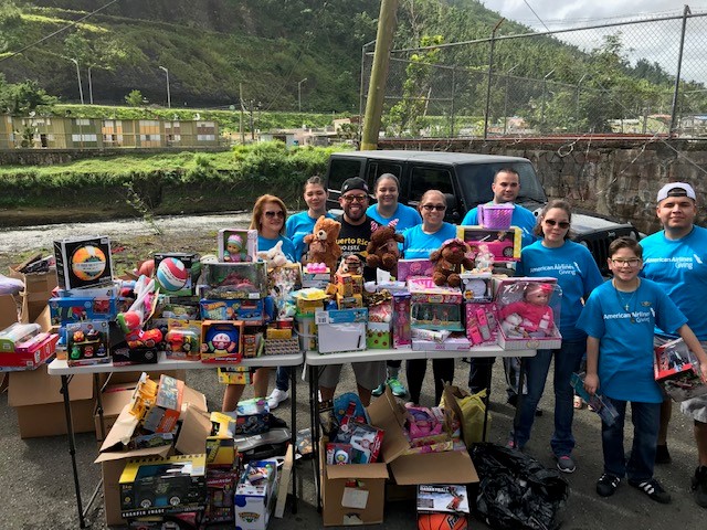 People standing in front of table of toys