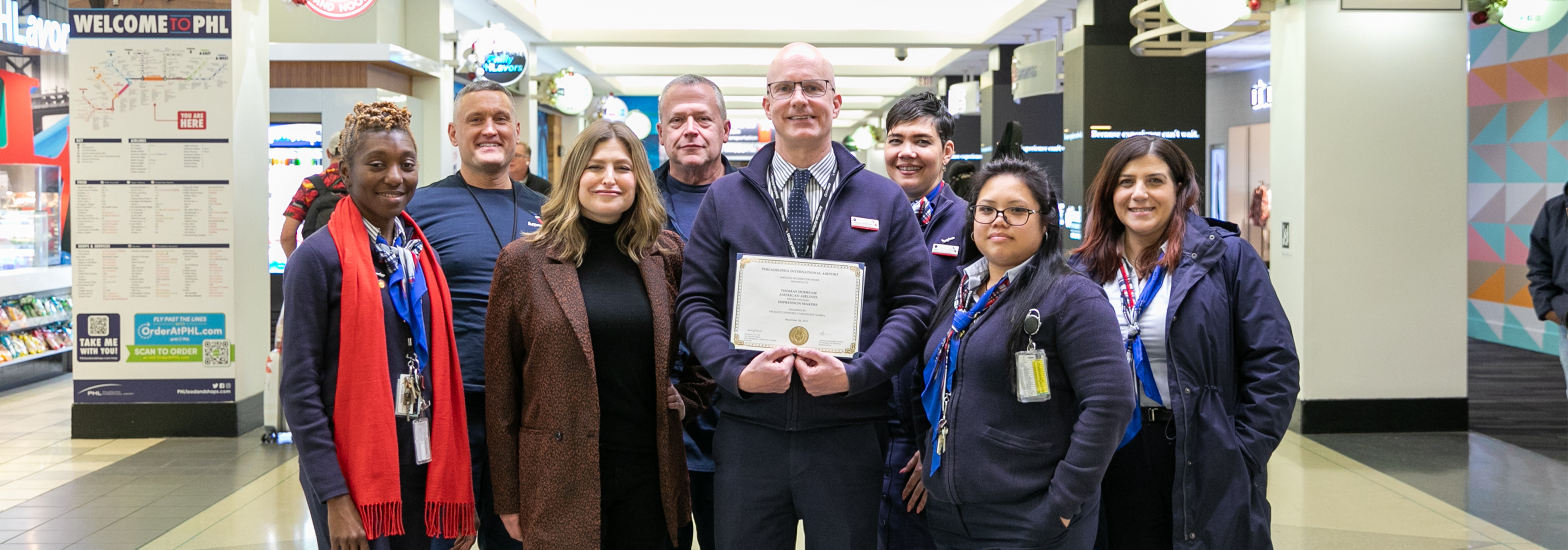 Thomas with GX team in terminals holding award
