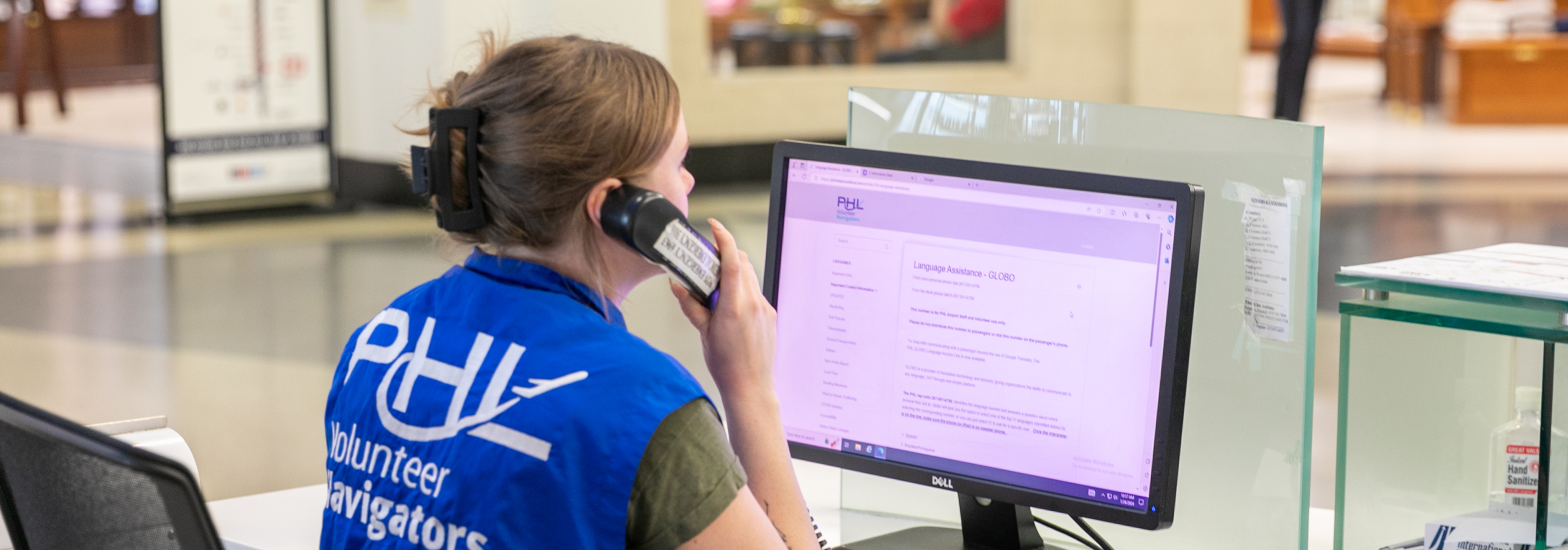 woman at information counter on the phone