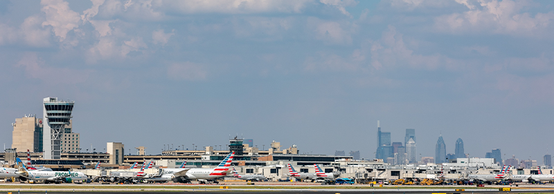 airfield with tower and planes and city background