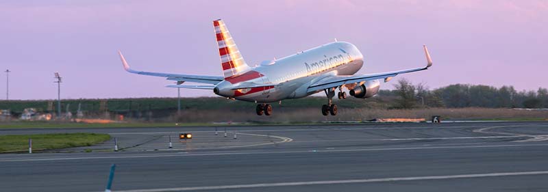 American Airlines plane on runway at sunset