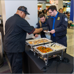 chickie's and Pete's employee serving cheesesteaks