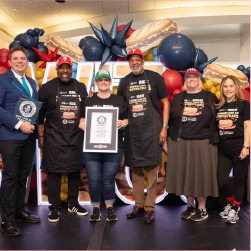 group of people holding work record award