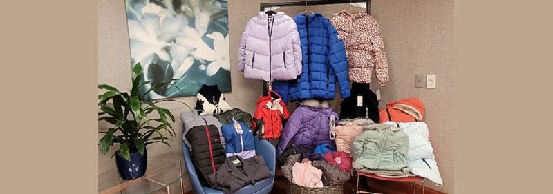 coats hanging up and on chairs