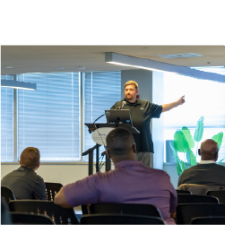 person pointing to screen while presenting