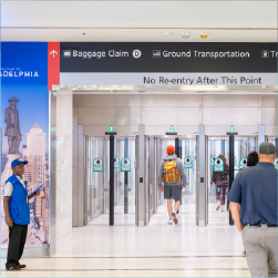 people walking through the exit doors