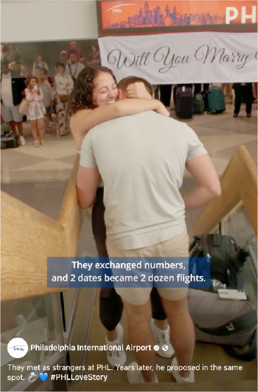 woman hugging man with will you marry me sign in background