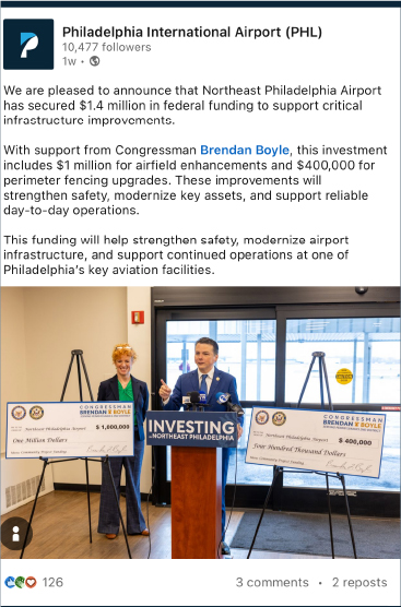 Photo of Tracey and Congressman with giant checks