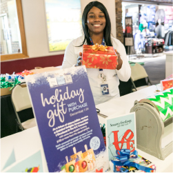 person presenting a wrapped gist in the B/C connector