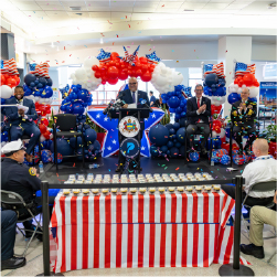 red white and blue balloons and decorations. people on stage