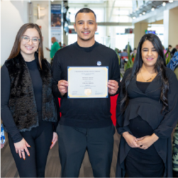 Ibrahim with coworkers holding certificate