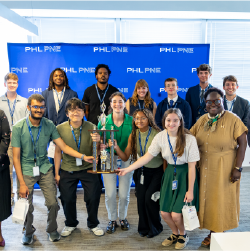 iX 25 shark tank winners holding trophy