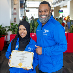 Kyhaan holding award next to her boss