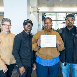 Nikki Brown with coworkers holding certificate