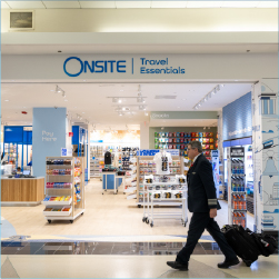 onsite news storefront with pilot walking past