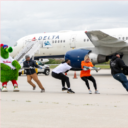 employees and Phillie Phanatic pulling plane