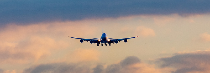 plane flying with blue cloudy sky
