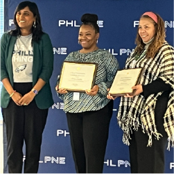 people holding framed certificates