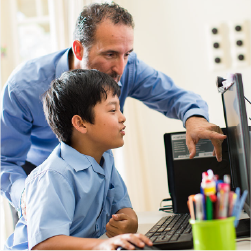 boy on computer with adult