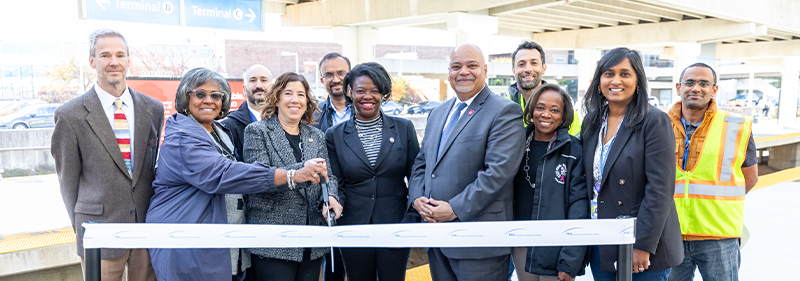 group of people cutting ribbon at SEPTA platform