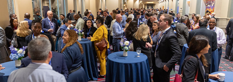 attendees standing at tables networking