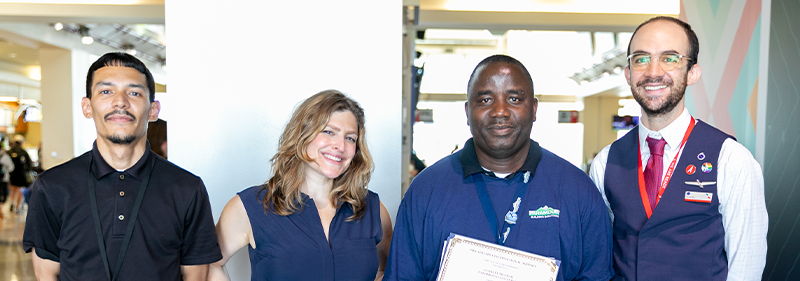 Stanly with co workers holding award