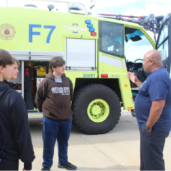 students on a tour at the airport firehouse