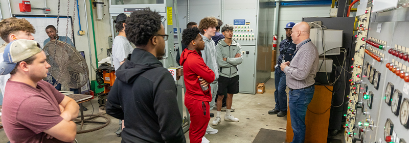 students listening to presentation in electrical room